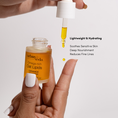 Dropping Urban Veda Oat Lipids Ceramide Booster onto a fingertip